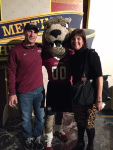 Bill Tucker is standing with the leopard with his wife, Barbara. 