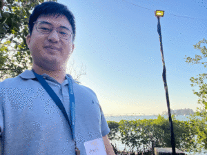 Amos Han '14 is wearing a blue shirt and a Lafayette nametag.  